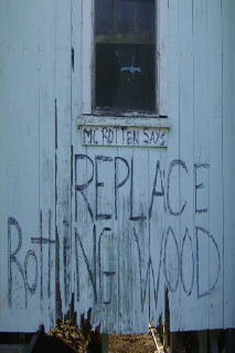 Original FixRot blue siding with the words Replace Rotting Wood
